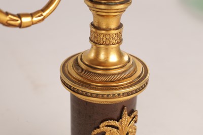 Lot 730 - A PAIR OF REGENCY FRENCH BRONZE AND GILT BRONZE TWO BRANCH CANDELABRA