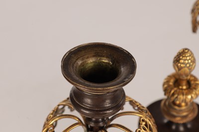 Lot 730 - A PAIR OF REGENCY FRENCH BRONZE AND GILT BRONZE TWO BRANCH CANDELABRA