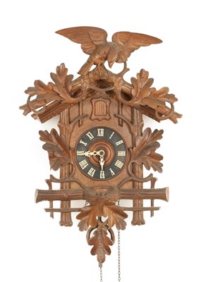 Lot 1442 - A LATE 19TH CENTURY GERMAN BLACK FOREST CARVED LINDEN WOOD CUCKOO CLOCK
