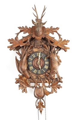 Lot 1418 - A LATE 19TH CENTURY GERMAN BLACK FOREST CARVED LINDEN WOOD CUCKOO CLOCK