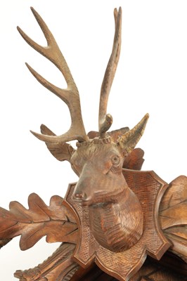 Lot 285 - A LATE 19TH CENTURY GERMAN BLACK FOREST CARVED LINDEN WOOD CUCKOO CLOCK