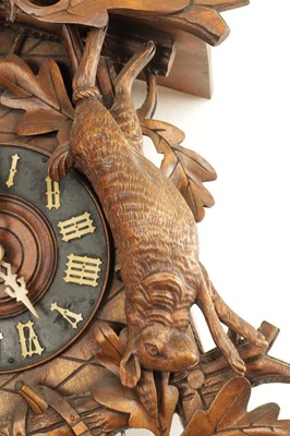 Lot 285 - A LATE 19TH CENTURY GERMAN BLACK FOREST CARVED LINDEN WOOD CUCKOO CLOCK