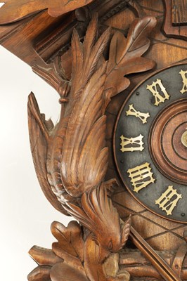 Lot 285 - A LATE 19TH CENTURY GERMAN BLACK FOREST CARVED LINDEN WOOD CUCKOO CLOCK