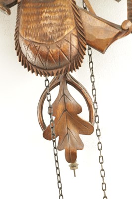 Lot 285 - A LATE 19TH CENTURY GERMAN BLACK FOREST CARVED LINDEN WOOD CUCKOO CLOCK