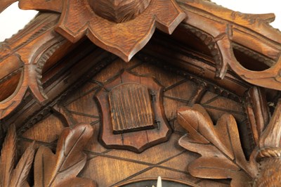 Lot 285 - A LATE 19TH CENTURY GERMAN BLACK FOREST CARVED LINDEN WOOD CUCKOO CLOCK