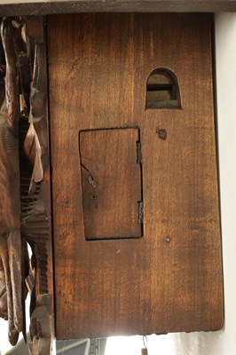 Lot 285 - A LATE 19TH CENTURY GERMAN BLACK FOREST CARVED LINDEN WOOD CUCKOO CLOCK