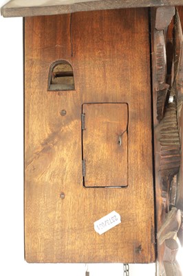 Lot 285 - A LATE 19TH CENTURY GERMAN BLACK FOREST CARVED LINDEN WOOD CUCKOO CLOCK