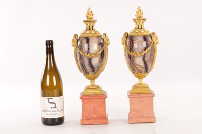 Lot 834 - A FINE PAIR OF LATE GEORGE III ORMOLU AND BLUE JOHN MANTEL URNS/CANDLE HOLDERS ON VEINED PINK MARBLE PEDESTAL BASES ATTRIBUTED TO MATTHEW BOULTON