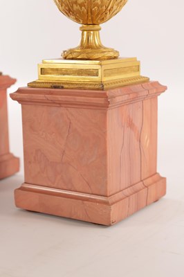 Lot 834 - A FINE PAIR OF LATE GEORGE III ORMOLU AND BLUE JOHN MANTEL URNS/CANDLE HOLDERS ON VEINED PINK MARBLE PEDESTAL BASES ATTRIBUTED TO MATTHEW BOULTON