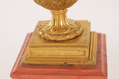 Lot 834 - A FINE PAIR OF LATE GEORGE III ORMOLU AND BLUE JOHN MANTEL URNS/CANDLE HOLDERS ON VEINED PINK MARBLE PEDESTAL BASES ATTRIBUTED TO MATTHEW BOULTON