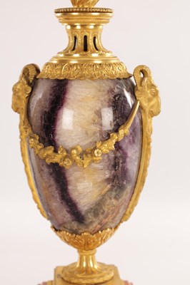 Lot 834 - A FINE PAIR OF LATE GEORGE III ORMOLU AND BLUE JOHN MANTEL URNS/CANDLE HOLDERS ON VEINED PINK MARBLE PEDESTAL BASES ATTRIBUTED TO MATTHEW BOULTON