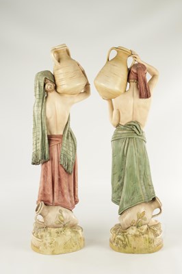 Lot 40 - A LARGE PAIR OF ROYAL DUX PORCELAIN FIGURES OF WATER CARRIERS