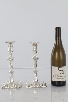 Lot 226 - A PAIR OF GEORGE III CAST SILVER CANDLESTICKS