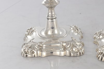 Lot 226 - A PAIR OF GEORGE III CAST SILVER CANDLESTICKS