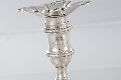 Lot 226 - A PAIR OF GEORGE III CAST SILVER CANDLESTICKS