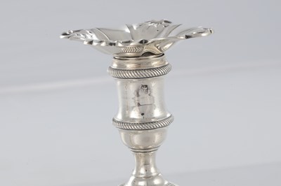 Lot 226 - A PAIR OF GEORGE III CAST SILVER CANDLESTICKS