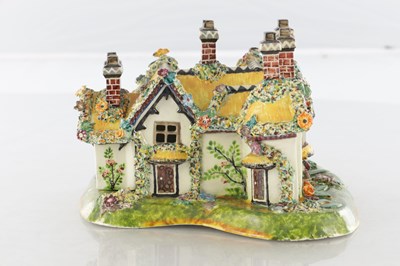 Lot 96 - A 19TH CENTURY STAFFORDSHIRE PORCELAIN "COTTAGE ORNEE" PASTILLE BURNER, AND A LEEDSWARE FLATBACK HOUSE