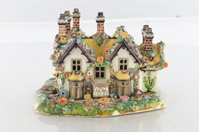 Lot 96 - A 19TH CENTURY STAFFORDSHIRE PORCELAIN "COTTAGE ORNEE" PASTILLE BURNER, AND A LEEDSWARE FLATBACK HOUSE