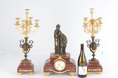 Lot A LATE 19TH CENTURY FRENCH BRONZE, ORMOLU AND ROUGE MARBLE CLOCK GARNITURE