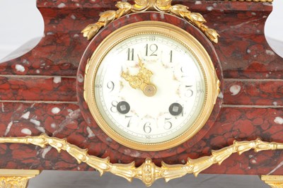 Lot A LATE 19TH CENTURY FRENCH BRONZE, ORMOLU AND ROUGE MARBLE CLOCK GARNITURE