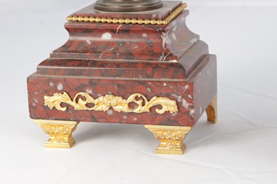 Lot A LATE 19TH CENTURY FRENCH BRONZE, ORMOLU AND ROUGE MARBLE CLOCK GARNITURE
