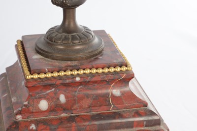 Lot A LATE 19TH CENTURY FRENCH BRONZE, ORMOLU AND ROUGE MARBLE CLOCK GARNITURE