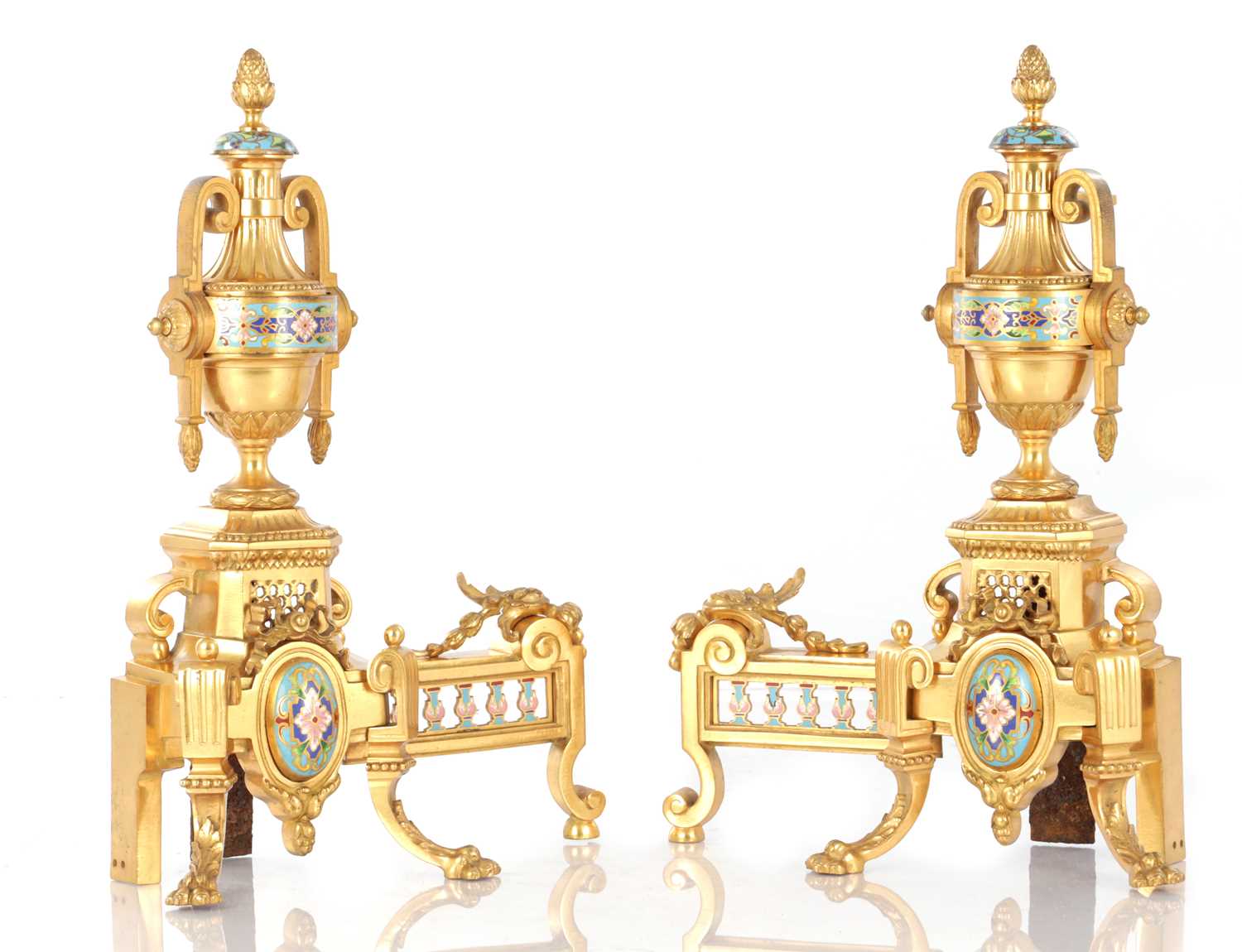 Lot A PAIR OF LATE 19TH CENTURY FRENCH ORMOLU AND CHAMPLEVE ENAMELLED FIRE DOGS