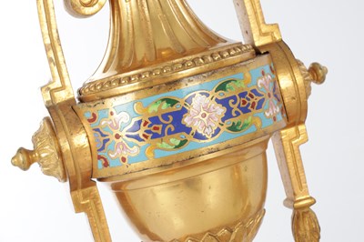 Lot A PAIR OF LATE 19TH CENTURY FRENCH ORMOLU AND CHAMPLEVE ENAMELLED FIRE DOGS