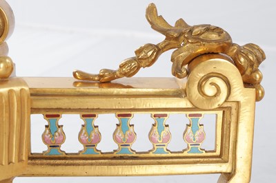 Lot A PAIR OF LATE 19TH CENTURY FRENCH ORMOLU AND CHAMPLEVE ENAMELLED FIRE DOGS