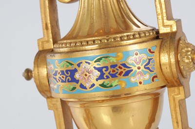 Lot A PAIR OF LATE 19TH CENTURY FRENCH ORMOLU AND CHAMPLEVE ENAMELLED FIRE DOGS