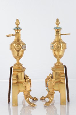 Lot A PAIR OF LATE 19TH CENTURY FRENCH ORMOLU AND CHAMPLEVE ENAMELLED FIRE DOGS