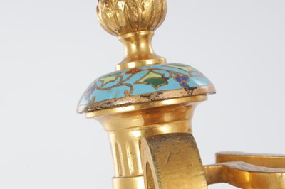 Lot A PAIR OF LATE 19TH CENTURY FRENCH ORMOLU AND CHAMPLEVE ENAMELLED FIRE DOGS