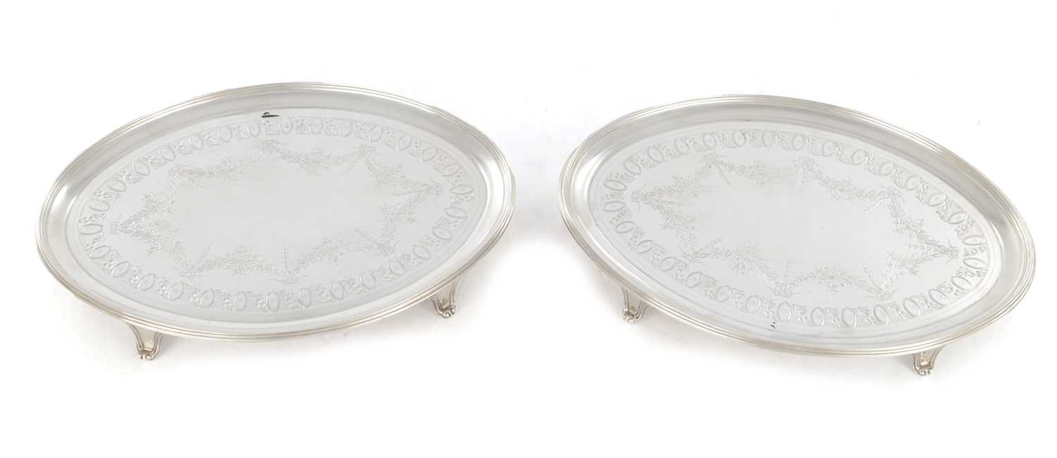 Lot 285 - A GOOD PAIR OF GEORGE III HEPPLEWHITE STYLE OVAL SILVER TRAYS