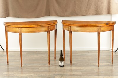 Lot 1715 - A PAIR OF GEORGE III INLAID SATINWOOD DEMI LUNE CARD TABLES IN THE MANNER OF MOORE OF DUBLIN