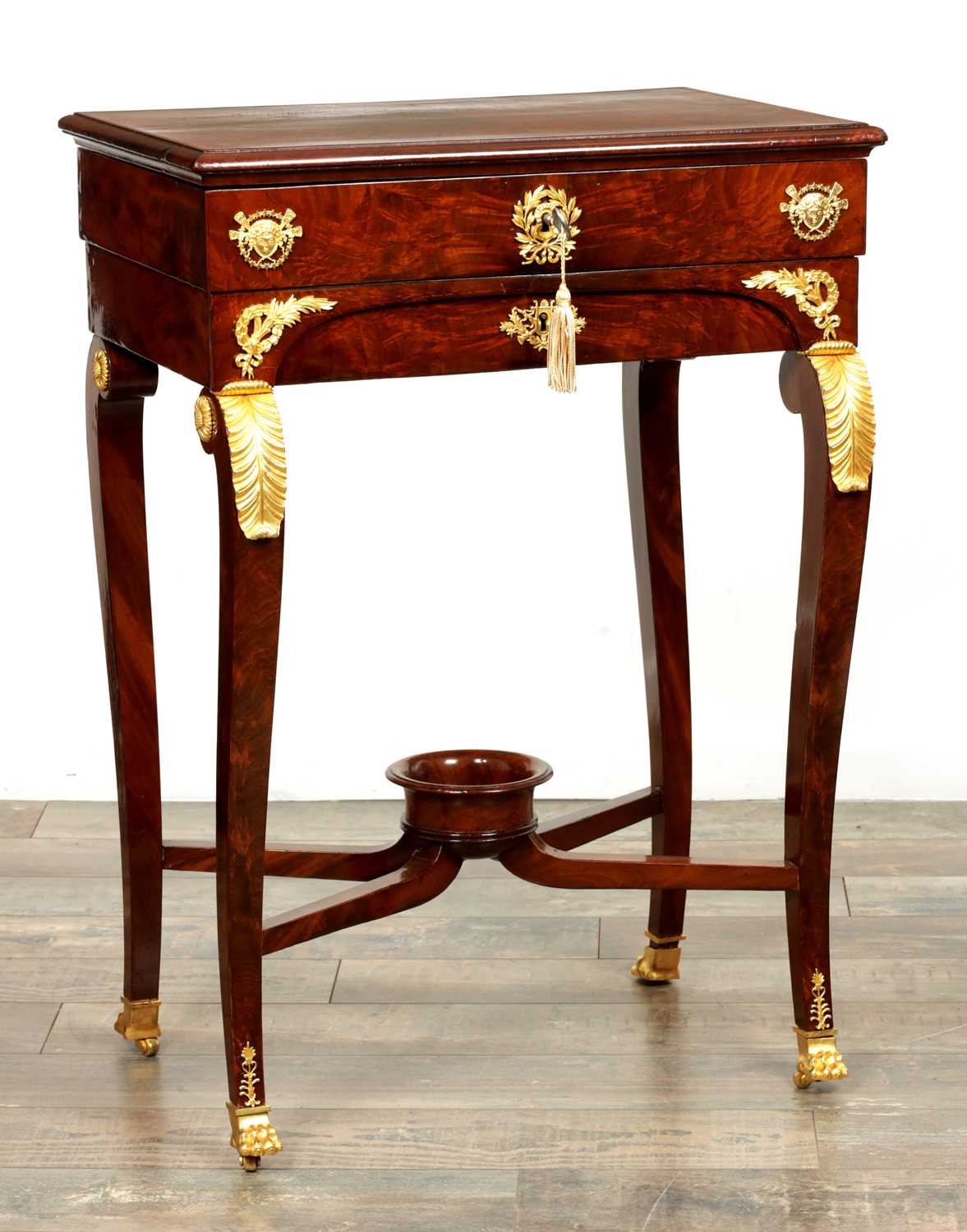 Lot 1687 - A 19TH CENTURY FRENCH EMPIRE FIGURED MAHOGANY AND ORMOLU MOUNTED WORK TABLE
