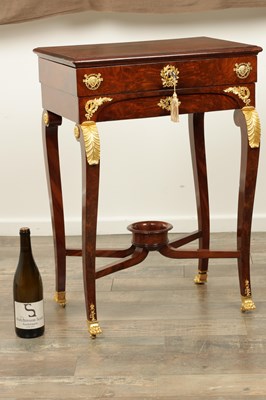 Lot 1687 - A 19TH CENTURY FRENCH EMPIRE FIGURED MAHOGANY AND ORMOLU MOUNTED WORK TABLE