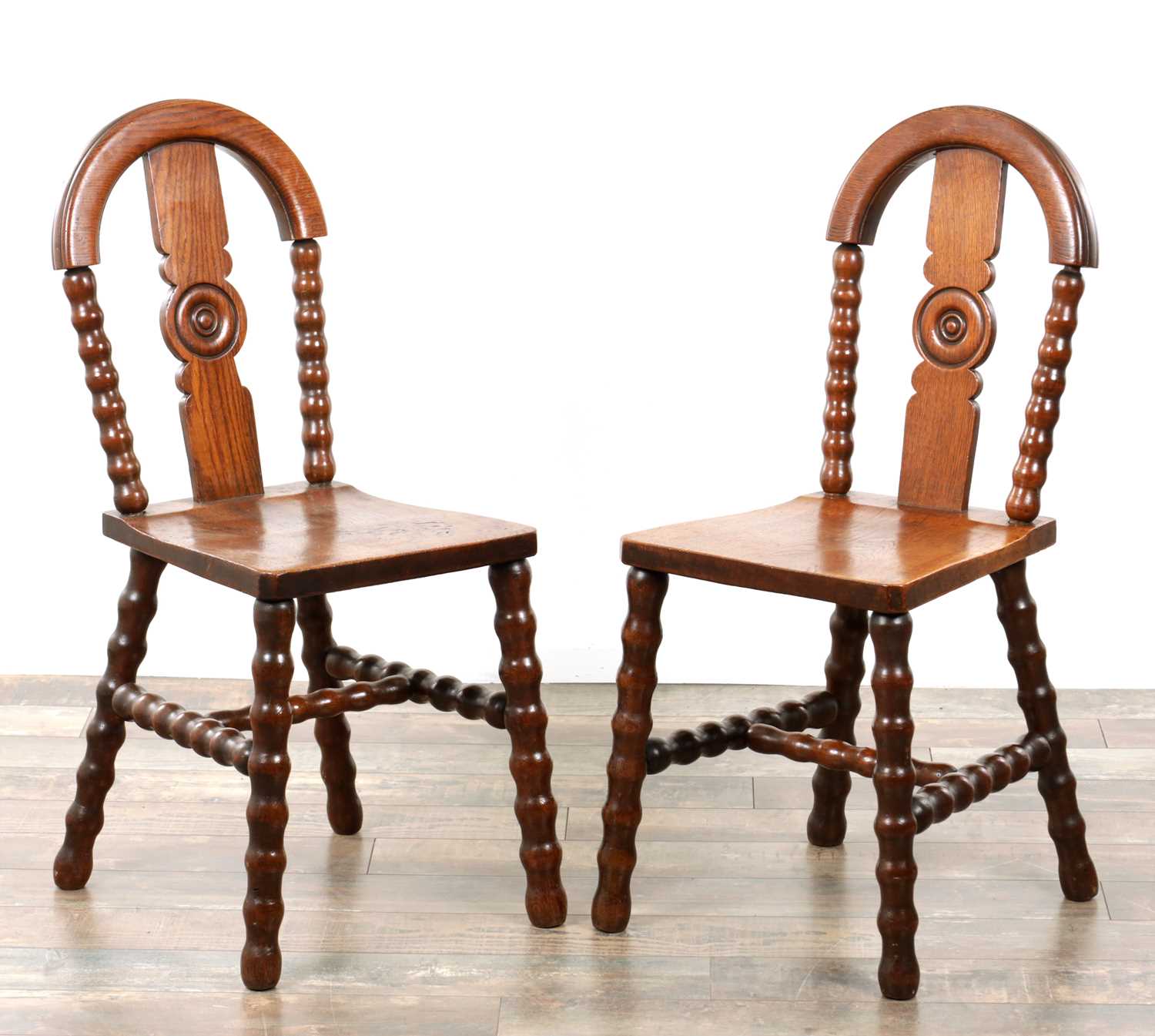 Lot 1590 - AN UNUSUAL PAIR OF ARTS AND CRAFTS OAK HALL CHAIRS