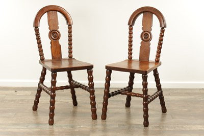 Lot 1590 - AN UNUSUAL PAIR OF ARTS AND CRAFTS OAK HALL CHAIRS