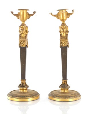 Lot 811 - A PAIR OF FRENCH REGENCY EGYPTIANESQUE BRONZE AND ORMOLU CANDLESTICKS