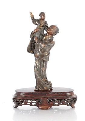 Lot 490 - A JAPANESE MEIJI PERIOD BRONZE WITH GILT HIGHLIGHTS OF AN ELDER WITH CHILD