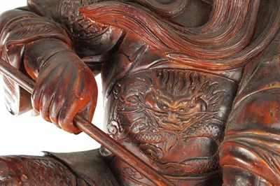 Lot 132 - A LATE 19TH CENTURY CARVED HARDWOOD FIGURE OF A WARRIOR STANDING ON A DRAGON