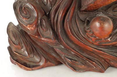 Lot 132 - A LATE 19TH CENTURY CARVED HARDWOOD FIGURE OF A WARRIOR STANDING ON A DRAGON
