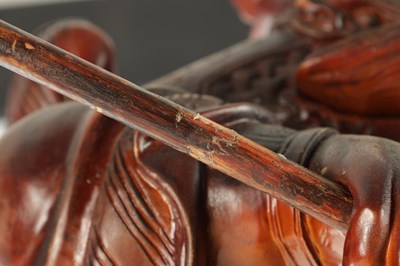 Lot 132 - A LATE 19TH CENTURY CARVED HARDWOOD FIGURE OF A WARRIOR STANDING ON A DRAGON