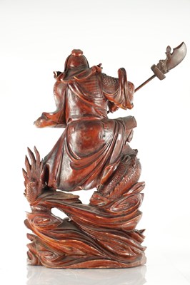 Lot 132 - A LATE 19TH CENTURY CARVED HARDWOOD FIGURE OF A WARRIOR STANDING ON A DRAGON