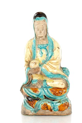 Lot 373 - A CHINESE MING DYNASTY FAHUA POTTERY FIGURE OF GUANYIN