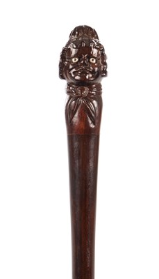 Lot 1066 - A LATE 19TH CENTURY CARVED LIGNUM VITAE WALKING STICK
