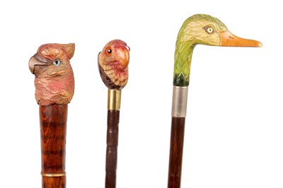 Lot 1064 - THREE LATE 19TH CENTURY CARVED AND PAINTED BIRD HEAD-HANDLED WALKING STICKS