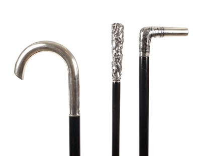 Lot 1081 - A COLLECTION OF THREE SILVER TOPPED WALKING STICKS