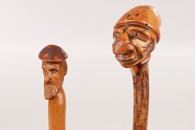 Lot 118 - TWO LATE 19TH CENTURY FOLK ART CARVED HEAD WALKING STICKS