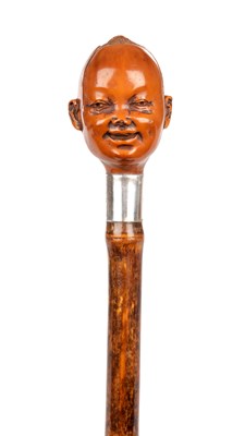 Lot 1073 - AN EARLY 20TH CENTURY CARVED COQUILLA NUT HANDLED WALKING STICK